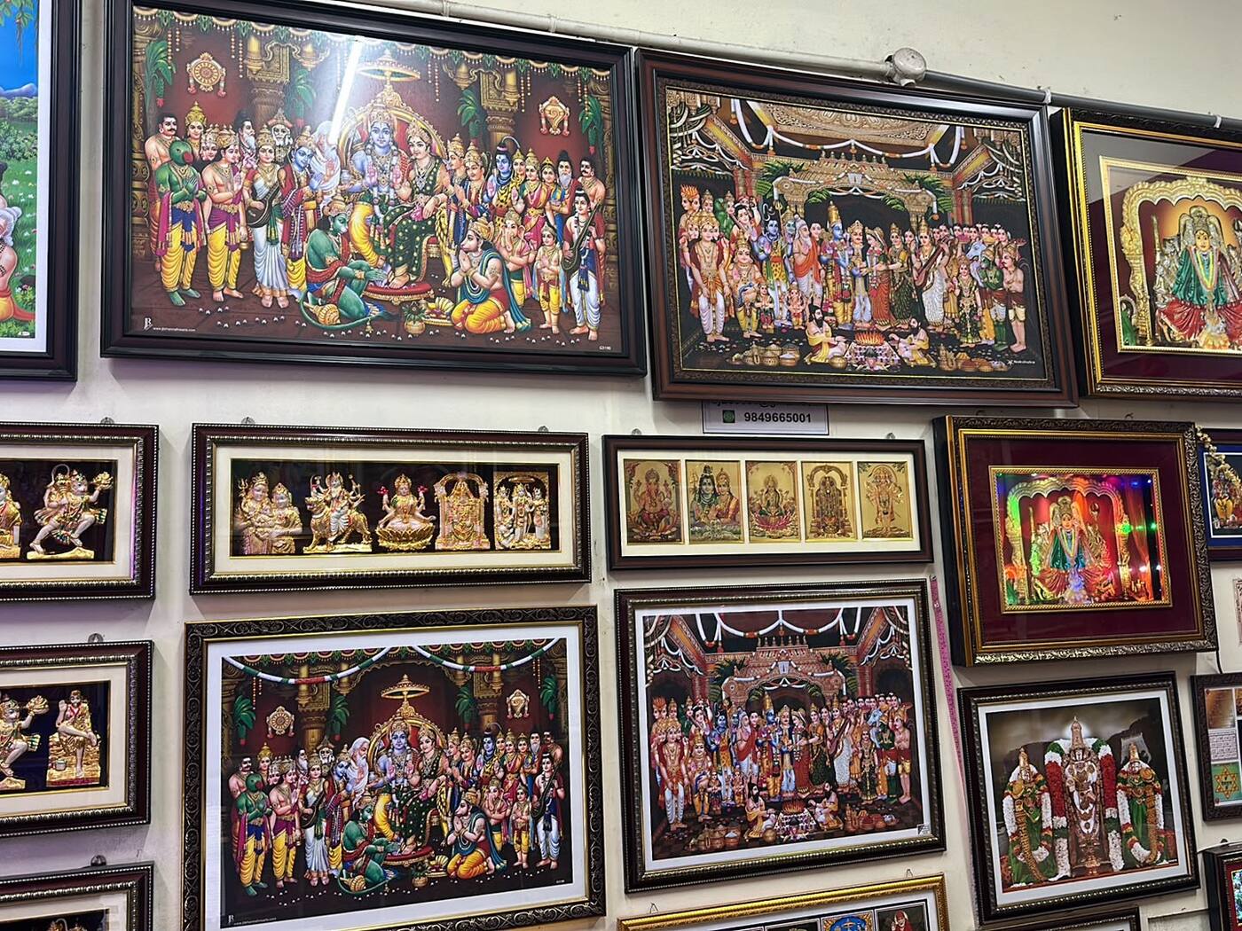 A display wall of devotional frames in carved mouldings at Frame Crafts